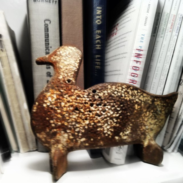 rusty shooting gallery duck with a lot of direct hits